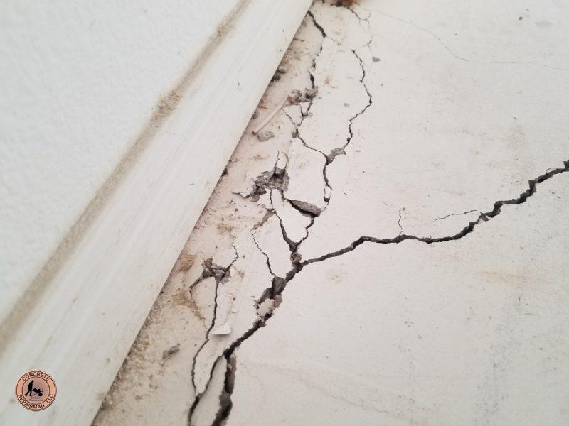 Floor heave cracks next to foundation footing walls is a sign of Settlement, not caused by expansive soils or clays.