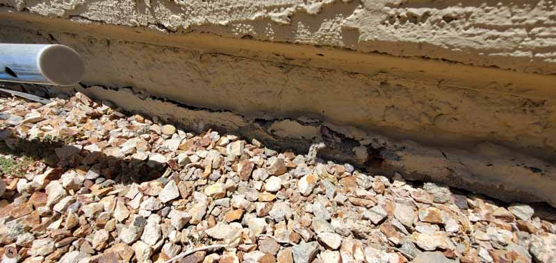 Concrete Repairman performing a Foundation Inspection to detect early signs of foundation damage — schedule your inspection today for expert protection.