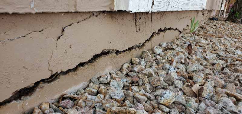 Concrete Repairman performing a Foundation Inspection to evaluate slab integrity and structural safety — schedule your inspection today for accurate diagnostics.