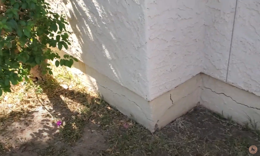 Specialist from Concrete Repairman inspecting foundation cracks on an Arizona home – get a trusted foundation inspection by calling (480) 725-7614.