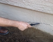 Cracked stem wall close-up with signs of damage—call Concrete Repairman at (480) 725-7614 for expert foundation inspection and repair.