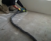 Cracked concrete floor close-up—call Concrete Repairman at (480) 725-7614 for expert crack stitching to protect your home.