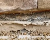 A corroded stem wall showing rusted rebar and cracked concrete being professionally repaired by Concrete Repairman LLC — call (480) 725-7614 today to protect your home’s foundation with expert repair services.