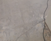 Minor floor cracks leading to major foundation damage with warning signs highlighted. Call Concrete Repairman LLC at (480) 725-7614 for expert foundation inspection and repair solutions today.